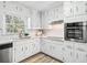 Updated kitchen featuring white cabinetry, quartz counters, stainless appliances, and hardwood flooring at 3448 Montreal Way, Tucker, GA 30084