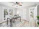 Bright office space features a ceiling fan, glass desk, and French doors to the yard at 3448 Montreal Way, Tucker, GA 30084