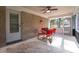 This patio features brick walls, railings, a ceiling fan, and a table with four red chairs at 3448 Montreal Way, Tucker, GA 30084