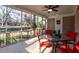 The patio has railings, a ceiling fan, and a table with four red chairs at 3448 Montreal Way, Tucker, GA 30084