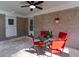 View of the patio with brick walls, a ceiling fan, and a table with red chairs at 3448 Montreal Way, Tucker, GA 30084