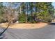 Street view of home on a corner lot with mature trees at 3448 Montreal Way, Tucker, GA 30084