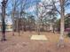 Private backyard with large trees and a concrete pad at 3657 Linda Dr, Loganville, GA 30052