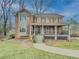 Brick house with wrap-around porch and landscaped yard at 3657 Linda Dr, Loganville, GA 30052