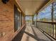 Side view of the front porch with wooden floors and railing at 3657 Linda Dr, Loganville, GA 30052