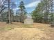 Tan shed nestled among mature trees at 3657 Linda Dr, Loganville, GA 30052