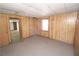 Unfinished basement room with wood paneling at 3035 Saint Andrews Dr, Duluth, GA 30096