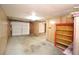 Unfinished basement with garage access and shelving at 3035 Saint Andrews Dr, Duluth, GA 30096