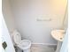 Clean half bathroom with pedestal sink and toilet at 3035 Saint Andrews Dr, Duluth, GA 30096