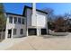 White house exterior with black garage doors and a large driveway at 3035 Saint Andrews Dr, Duluth, GA 30096