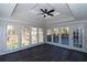 Sunroom with hardwood floors, multiple windows, and ceiling fan at 3035 Saint Andrews Dr, Duluth, GA 30096