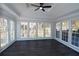 Sunroom addition with abundant windows and dark flooring at 3035 Saint Andrews Dr, Duluth, GA 30096