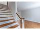 Staircase with wooden steps and a white banister next to a living area at 3103 Colonial Way # A, Chamblee, GA 30341