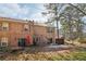 View of the backyard and patio of a brick townhome featuring mature trees and a secure fence at 3420 Ashwood Ln # 3420, Atlanta, GA 30341