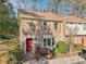 Charming brick townhome featuring a red front door and well-maintained landscaping at 3420 Ashwood Ln # 3420, Atlanta, GA 30341