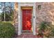 Close-up of the red front door framed by white pillars and brick facade at 3420 Ashwood Ln # 3420, Atlanta, GA 30341