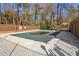 Community pool with a cover, surrounded by mature trees at 3420 Ashwood Ln # 3420, Atlanta, GA 30341