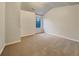 Bright bedroom with neutral carpeting and a window at 4444 Spring Mtn Ln, Powder Springs, GA 30127