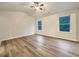 Large bedroom with hardwood floors and two windows at 4444 Spring Mtn Ln, Powder Springs, GA 30127