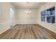 Bright dining room features hardwood floors, wainscoting, and a chandelier at 4444 Spring Mtn Ln, Powder Springs, GA 30127