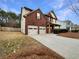 Two-story home with two-car garage and manicured lawn at 4444 Spring Mtn Ln, Powder Springs, GA 30127