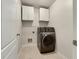 Convenient laundry room with washer, dryer, and cabinets at 4444 Spring Mtn Ln, Powder Springs, GA 30127