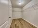 Large walk-in closet with wire shelving and light wood flooring at 4444 Spring Mtn Ln, Powder Springs, GA 30127