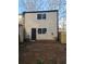 Back exterior of home with backyard and privacy fence at 5581 Marbut Rd, Lithonia, GA 30058