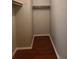 Walk-in closet with installed shelves and hardwood floor at 5581 Marbut Rd, Lithonia, GA 30058