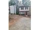 Traditional two-story home showcasing a brick facade, red shutters, and a quaint front yard at 5581 Marbut Rd, Lithonia, GA 30058