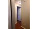 Hallway with hardwood floors, base trim, and doors leading to various rooms of the home at 5581 Marbut Rd, Lithonia, GA 30058