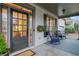 Inviting front porch with rocking chairs and hanging plants at 627 Village Manor Pl, Suwanee, GA 30024