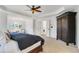 Bright main bedroom with ceiling fan, hardwood floors and walk-in closet at 627 Village Manor Pl, Suwanee, GA 30024