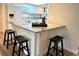 Kitchen view showcasing a granite countertop breakfast bar with black stools and white cabinets at 2249 Runnymead Se Rdg, Marietta, GA 30067