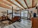 Bedroom with a four post wooden bed, wood paneled walls and ceiling, and modern floors at 255 Marks Way, Canton, GA 30115