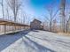 Exterior view of a home with ample gravel parking and lush surroundings, offering privacy and seclusion at 255 Marks Way, Canton, GA 30115