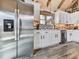 Modern kitchen with stainless steel refrigerator, white cabinets, and decorative backsplash at 255 Marks Way, Canton, GA 30115