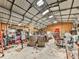 Vast warehouse filled with equipment and storage, featuring barrels, metal sheeting, and concrete flooring at 255 Marks Way, Canton, GA 30115