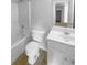 Clean, well-lit bathroom features a tub, toilet, vanity with sink, and modern fixtures at 2756 Palmview Sw Ct, Atlanta, GA 30331