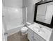 Bathroom with white vanity, a mirror, and tub-shower combination with wood-look vinyl flooring at 2756 Palmview Sw Ct, Atlanta, GA 30331