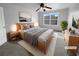 Comfortable bedroom with modern furniture, a ceiling fan, large window, and decorative artwork at 2756 Palmview Sw Ct, Atlanta, GA 30331