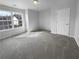 Well-lit bedroom with a large window and plush carpet flooring at 2756 Palmview Sw Ct, Atlanta, GA 30331