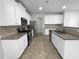 Kitchen with white cabinets, granite countertops, and stainless steel appliances at 2756 Palmview Sw Ct, Atlanta, GA 30331