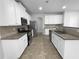 Well-lit kitchen with stainless steel appliances, granite countertops, and ample white cabinetry at 2756 Palmview Sw Ct, Atlanta, GA 30331