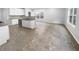 Eat-in kitchen with an island featuring modern appliances and tiled flooring at 2756 Palmview Sw Ct, Atlanta, GA 30331