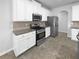 Well-lit kitchen with stainless steel appliances, granite countertops, and ample white cabinetry at 2756 Palmview Sw Ct, Atlanta, GA 30331