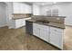 Modern kitchen island featuring granite counters, sink and stainless dishwasher at 2756 Palmview Sw Ct, Atlanta, GA 30331