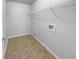 Bright laundry room featuring tile flooring and a wire rack shelf for ample storage at 2756 Palmview Sw Ct, Atlanta, GA 30331