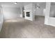 Spacious living room featuring a centered fireplace, plush carpet, and ample natural light at 2756 Palmview Sw Ct, Atlanta, GA 30331
