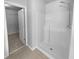 Modern bathroom shower with white tile, chrome fixtures and tile flooring at 2756 Palmview Sw Ct, Atlanta, GA 30331